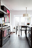Open plan dining room and galley kitchen in contemporary home, Hove, East Sussex, England, UK