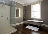 Spacious bathroom with freestanding bath and glass shower cubicle