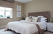 Double bedroom in shades of brown in contemporary London home, England, UK