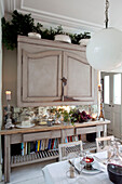 Wall mounted cupboard and console in dining room of London home, England, UK