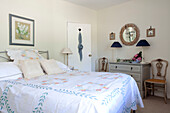 Pair of lamps on chest of drawers in bedroom of Sussex cottage, England, UK