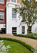 Front path and garden to white London townhouse, England, UK