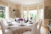 Cream and white dining table set for dinner in Sussex country house, England, UK