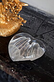 Daum glass paperweight with hands indented and gold ornaments on mantlepiece in London townhouse, England, UK