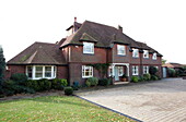 Brick exterior and driveway of detached house in Kent, England, UK