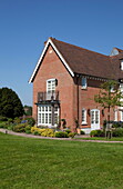 Detached brick exterior of Kent home set in grounds England UK