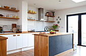 Kitchen island with blackboard paint and open shelves Kent family home England UK