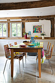 Wooden dining table and chairs in timber-framed Herefordshire home, England, UK