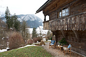 Klappstühle unter dem Balkon eines Bergchalets in Chateau-d'Oex, Waadt, Schweiz