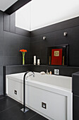 Modern white bath below skylight in SW London home, England, UK