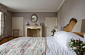Floral quilt with co-ordinating curtains in double bedroom of Burwash home East Sussex England UK