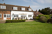 Garden furniture and parasol on terrace exterior of West Maling home Kent England UK