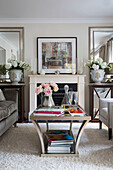 Decanter on glass-topped coffee table in living room of London home   England   UK