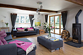 Pink blanket and cushions in living room with grey furniture  Warminster country house  Wiltshire  England  UK