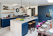 Open plan dining room kitchen with blue paintwork in contemporary London home, England, UK