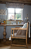 Wicker chair at desk below window in Wokingham cottage Berkshire UK