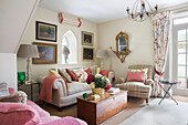 Sofa and armchairs with wooden blanket box in Dorset living room England UK