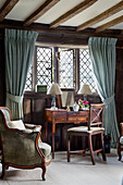 Dressing table and chairs at leaded glass window in timber framed Kent farmhouse UK