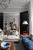 Black double doors opening to double reception room in London townhouse UK