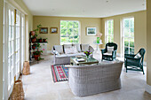 Wicker furniture and houseplants on stand in Grade II listed Georgian country house in Shropshire England UK