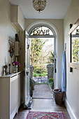 View through open door with single word 'LOVE' in fanlight window of Sussex home England UK