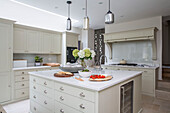 Pendant shades above kitchen island in London townhouse UK