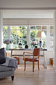 Brown leather chair at desk in window of West Sussex home