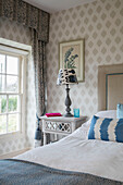 Blue striped pillow with lamp and curtains in Dorset farmhouse UK