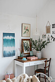 Artworks surrounding desk and chair in 19th century Victorian cottage Warwickshire