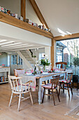 Christmas cards on timber frame above open plan dining room in West Sussex farmhouse UK