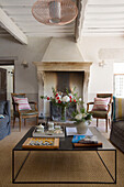 Pair of chairs at fireside with low coffee table in 19th century Provencal farmhouse France