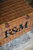 Wicker basket with letters 'F&M' in Gloucestershire barn conversion UK