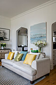 Pastel cushions on white sofa with art canvas in Grade II listed villa Arundel West Sussex UK