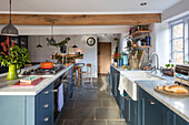 Redesigned kitchen painted in painted Hicks? Blue with limestone flooring in Grade II listed Hampshire cottage built c1500