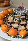 Mince pies and oranges with leaf decoration in East Dulwich home London UK
