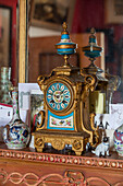 Antike Uhr mit chinesischen Ornamenten auf dem Kaminsims in einem Haus in Sussex