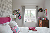 PInboard and geometric wallpaper with pink accents in teenagers room Victorian coach house West Sussex UK