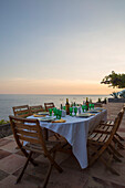 Table set at dusk on terrace of Italian villa on the Amalfi coast