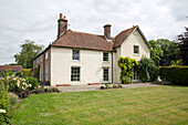 Paved terrace and lawn of detached Hampshire home England UK