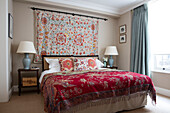 Double bed with handmade textiles in North London apartment UK