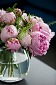 Pink peonies in glass vase in Hampshire home UK