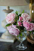 PInk peonies on sideboard in Surrey cottage UK