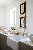 Mixing bowl and eggshells on work top with butler sink in Surrey kitchen without wall units for clutter free space UK