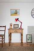 Salvaged table with red anglepoise from car boot sale Barrow in Furness Cumbria UK