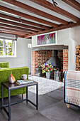 Green sofa and side table in beamed cottage Surrey UK