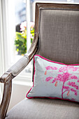 Pear tree cushion on beige armchair London UK