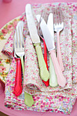 KNives and forks on floral napkins
