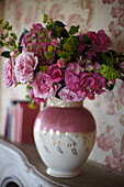 Vintage Blooms - Vase of cut flowers in a pink lustred jug on a mantlepiece