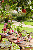 Late Summer picnic in garden with cakes fruit and flowers