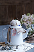 Enamel teapot converted to a pin cushion